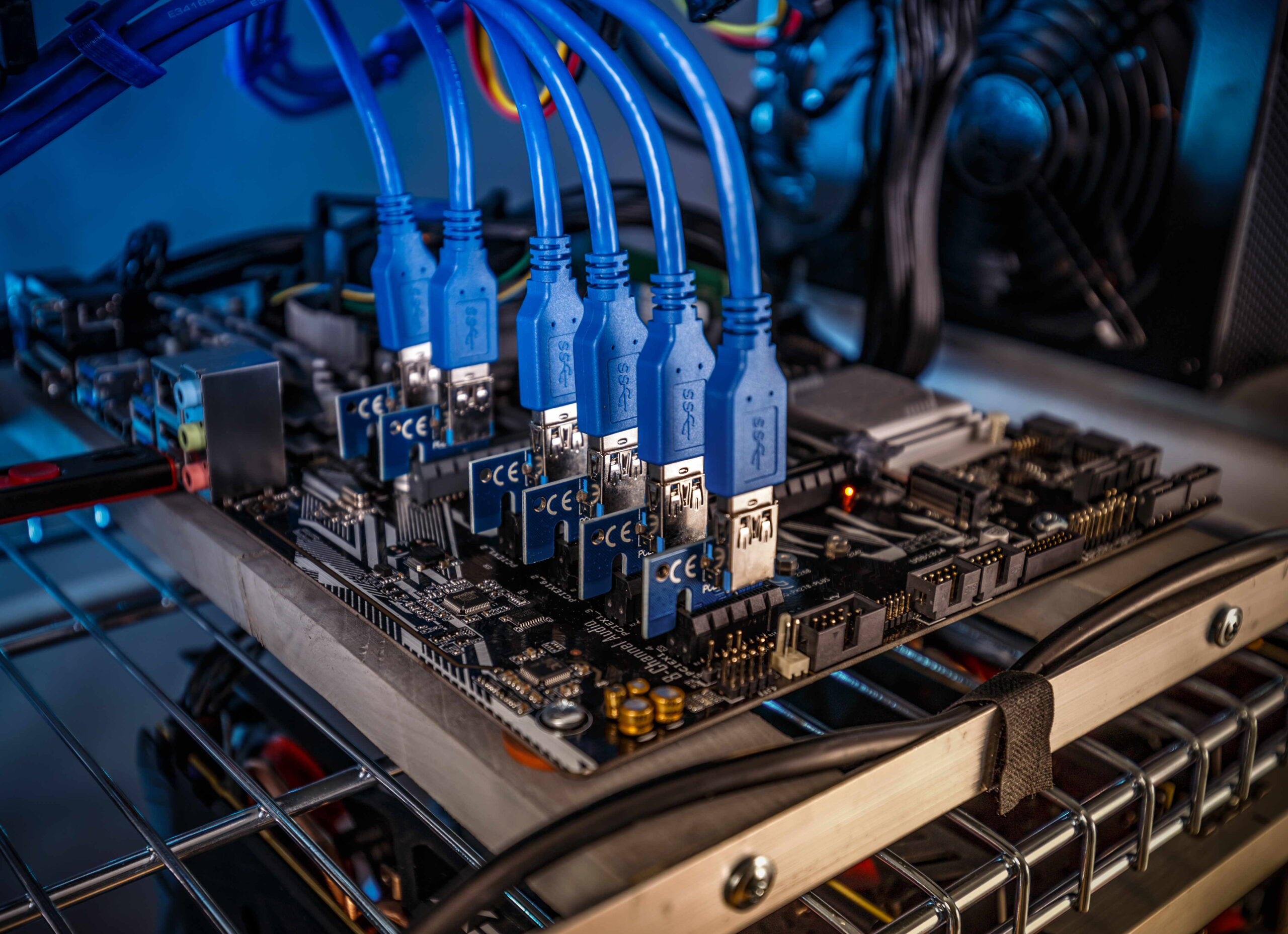 Cryptocurrency mining rig PCIe riser extenders plugged to motherboard