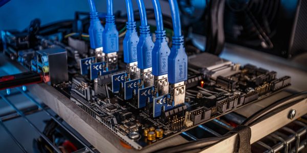 Cryptocurrency mining rig PCIe riser extenders plugged to motherboard